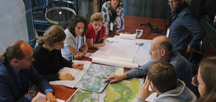 Group planning a city area in a roundtable setting.