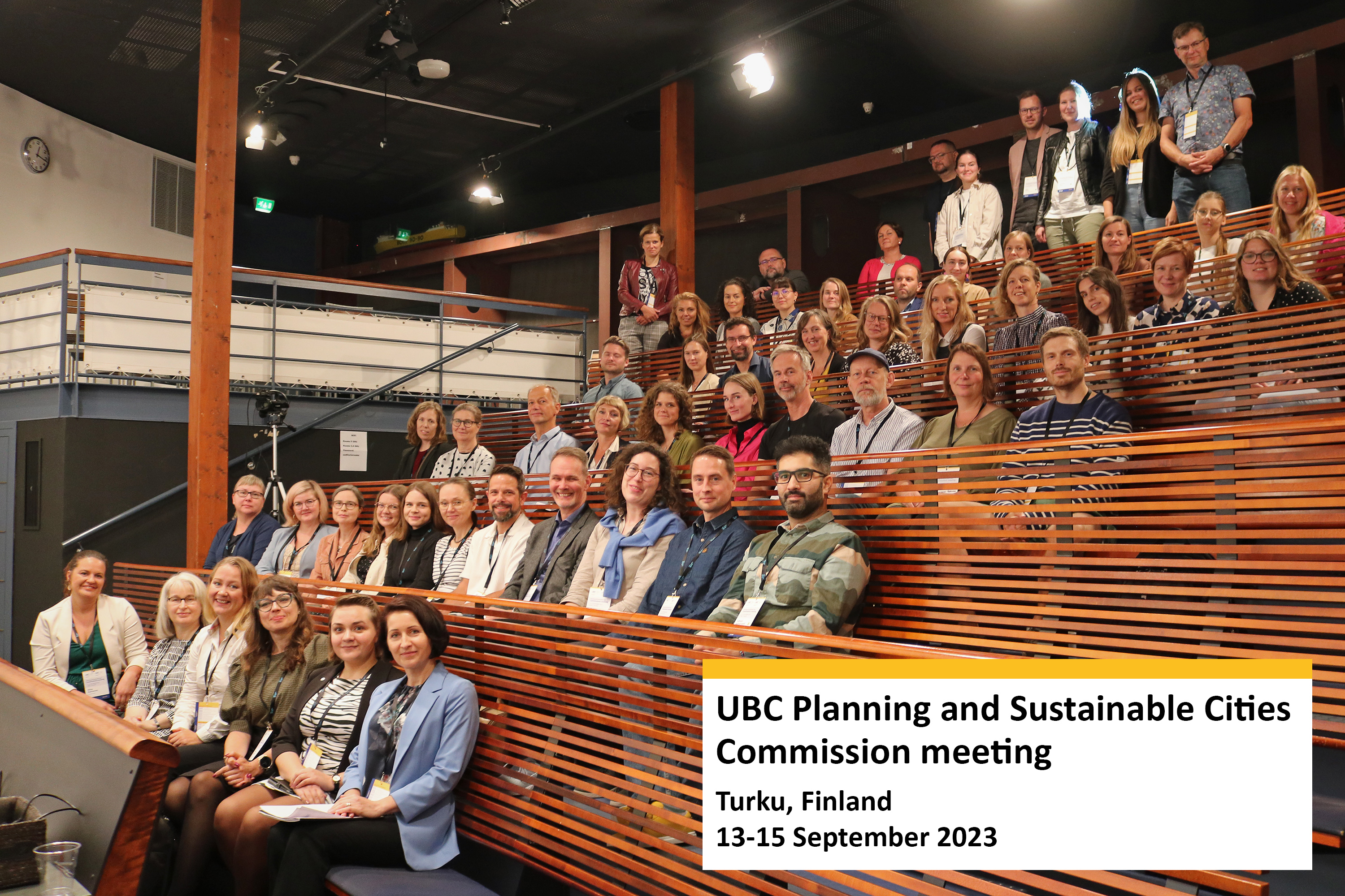 Group picture with participants of the event sitting in the auditorium room.