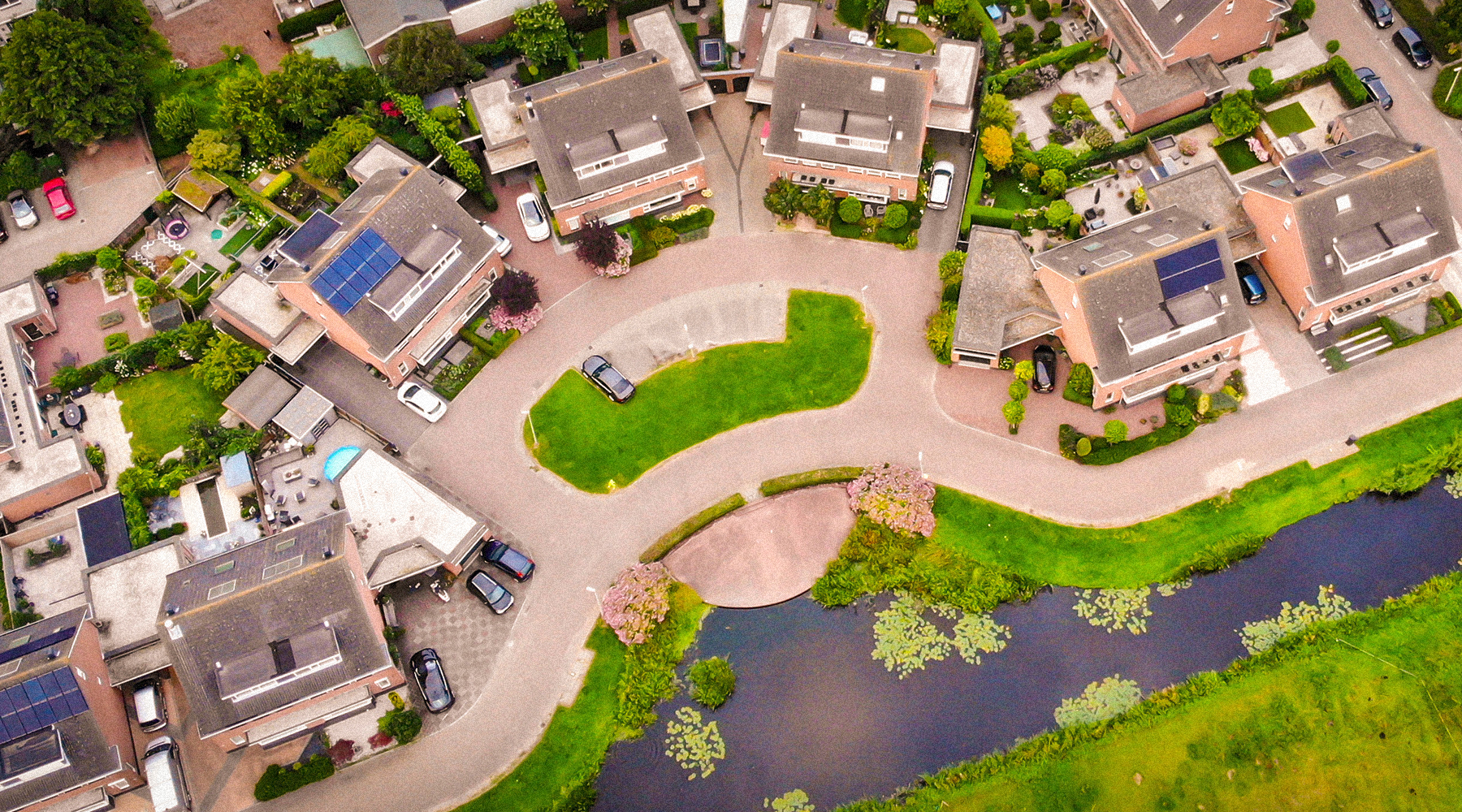 Aerial view on the green city district equipped with solar panels