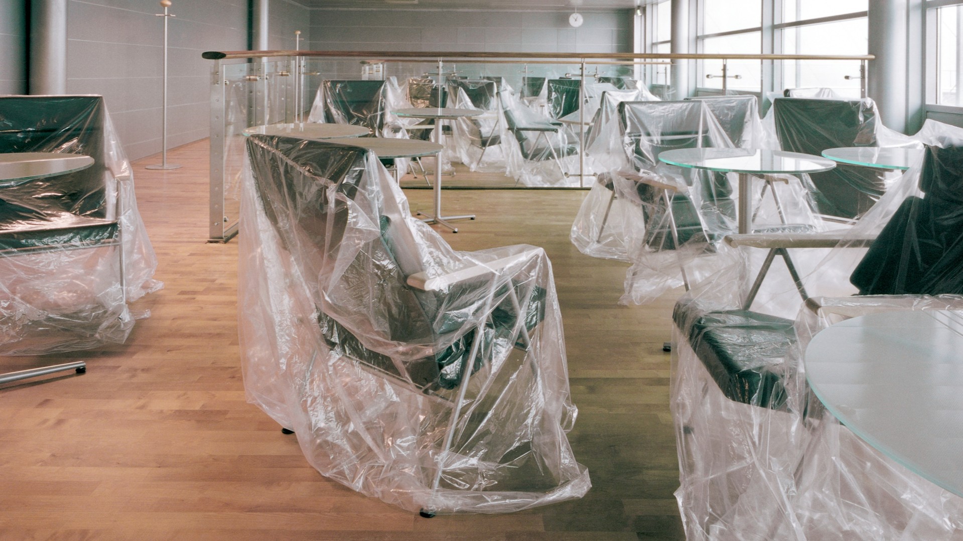 Office with chairs covered in plastic wrap.