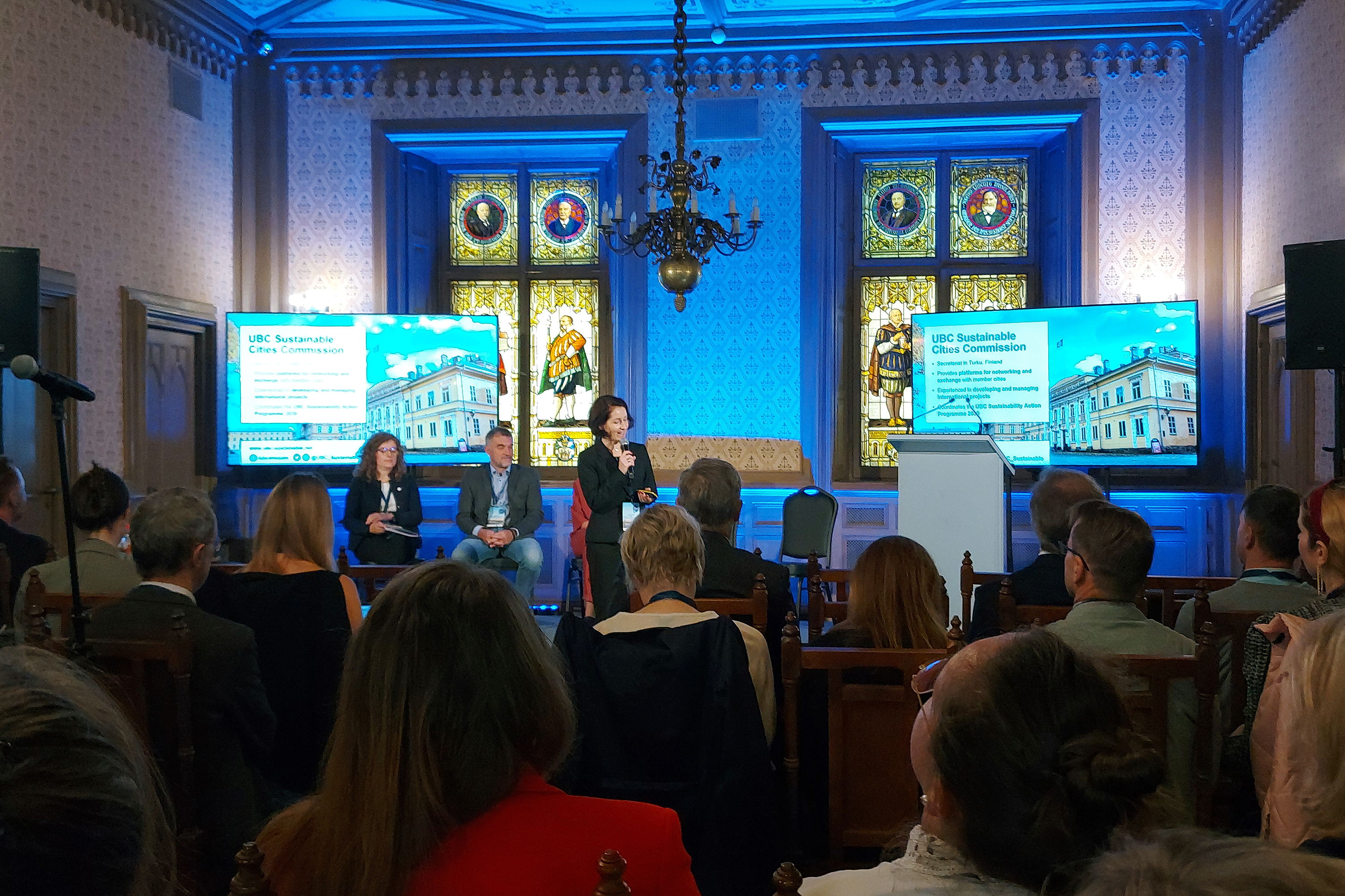 Agnieszka Ilola on the stage delivering the presentation.