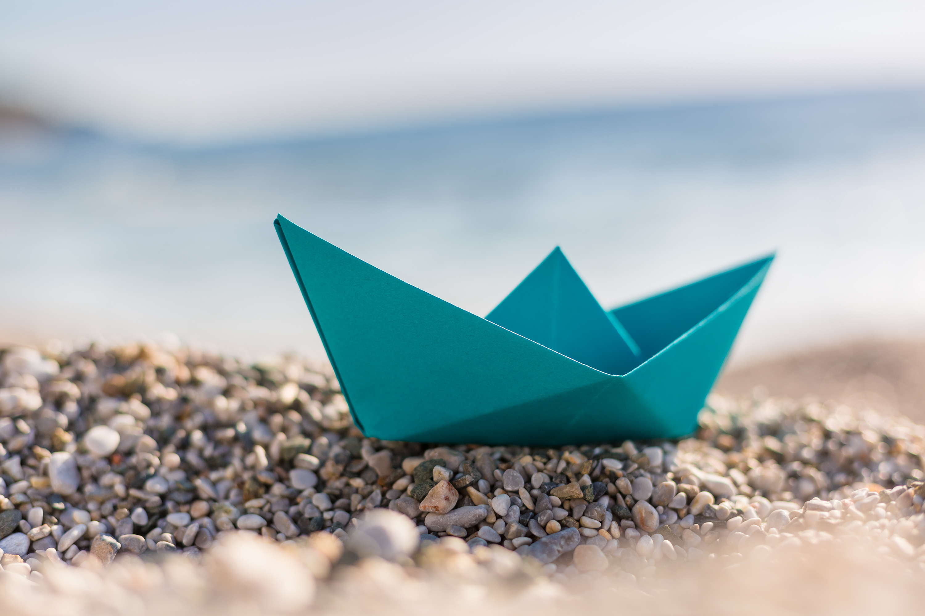 Paper boat on the shore